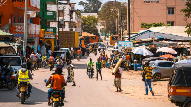 A street scene of people and motorbike in the Kenyan city of Malindi.