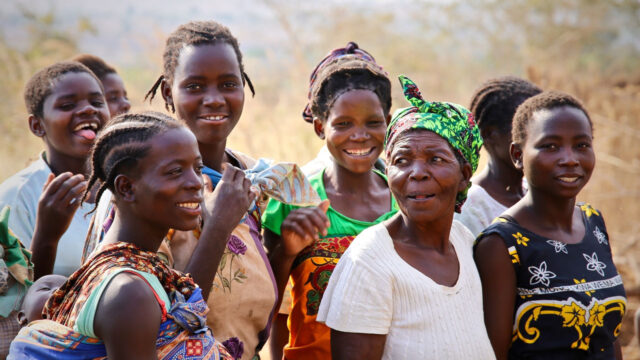 Several Malawian women and girls enjoying a walk together outdoors