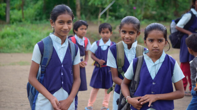 Several schoolgirls outside smiling