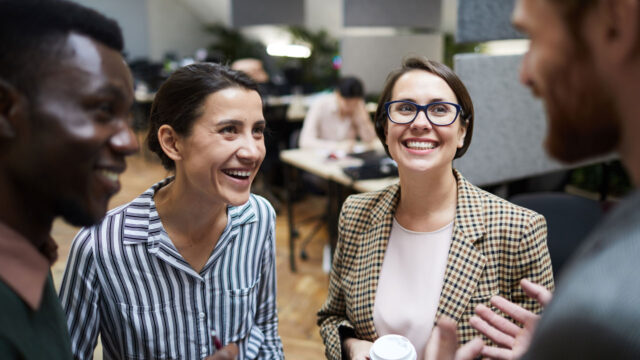 Staff members in an office space chatting