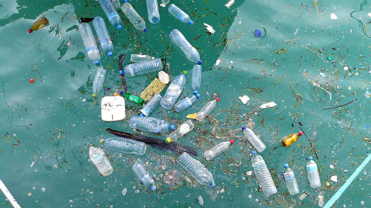 Plastic waste floating in ocean water