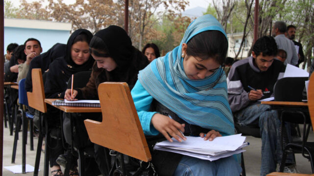 A classroom full of schoolchildren working on projects at their desks