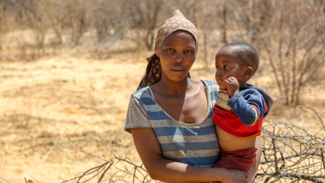 A mother holding her toddler